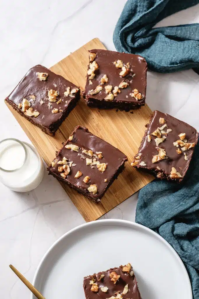 Chocolate buttermilk cake cut into squares on a wooden board