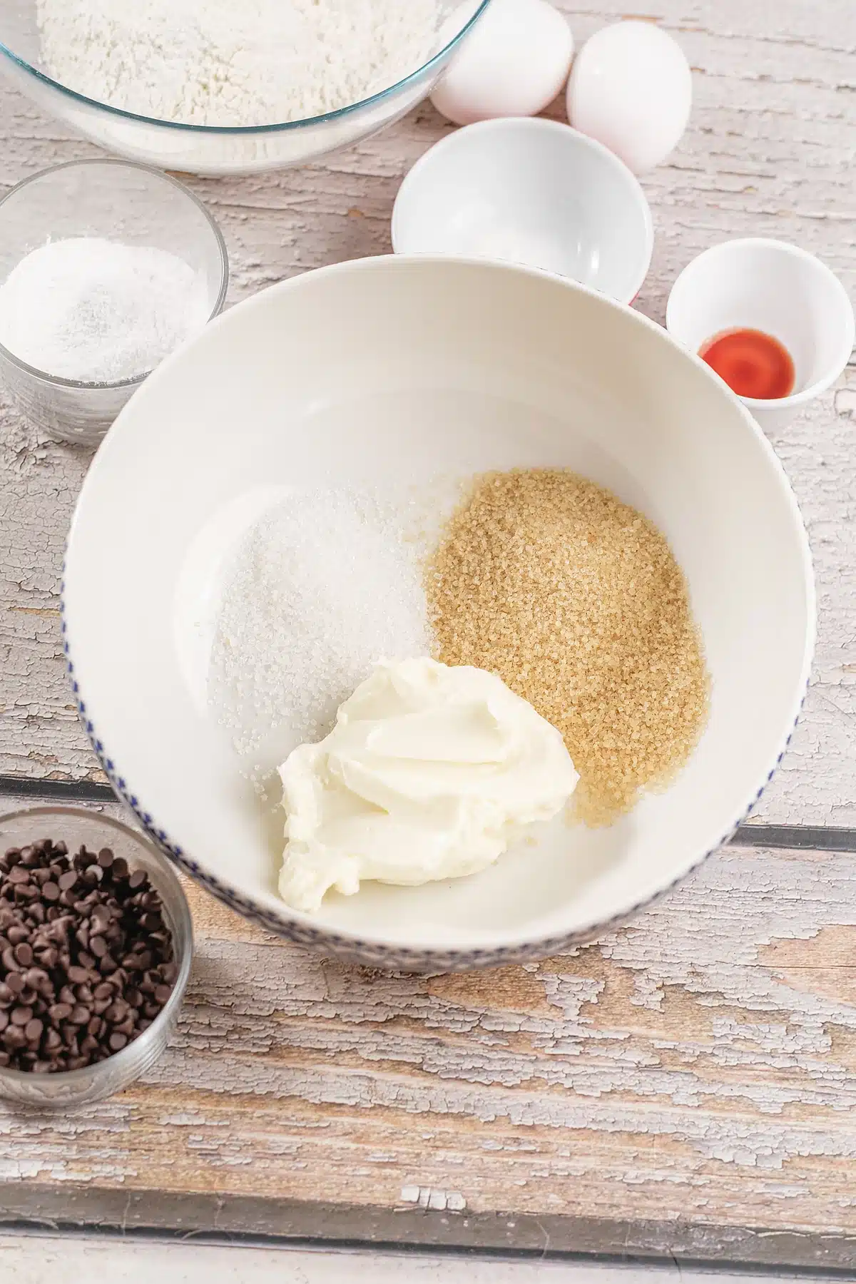 Butter and both sugars in a white mixing bowl before beating
