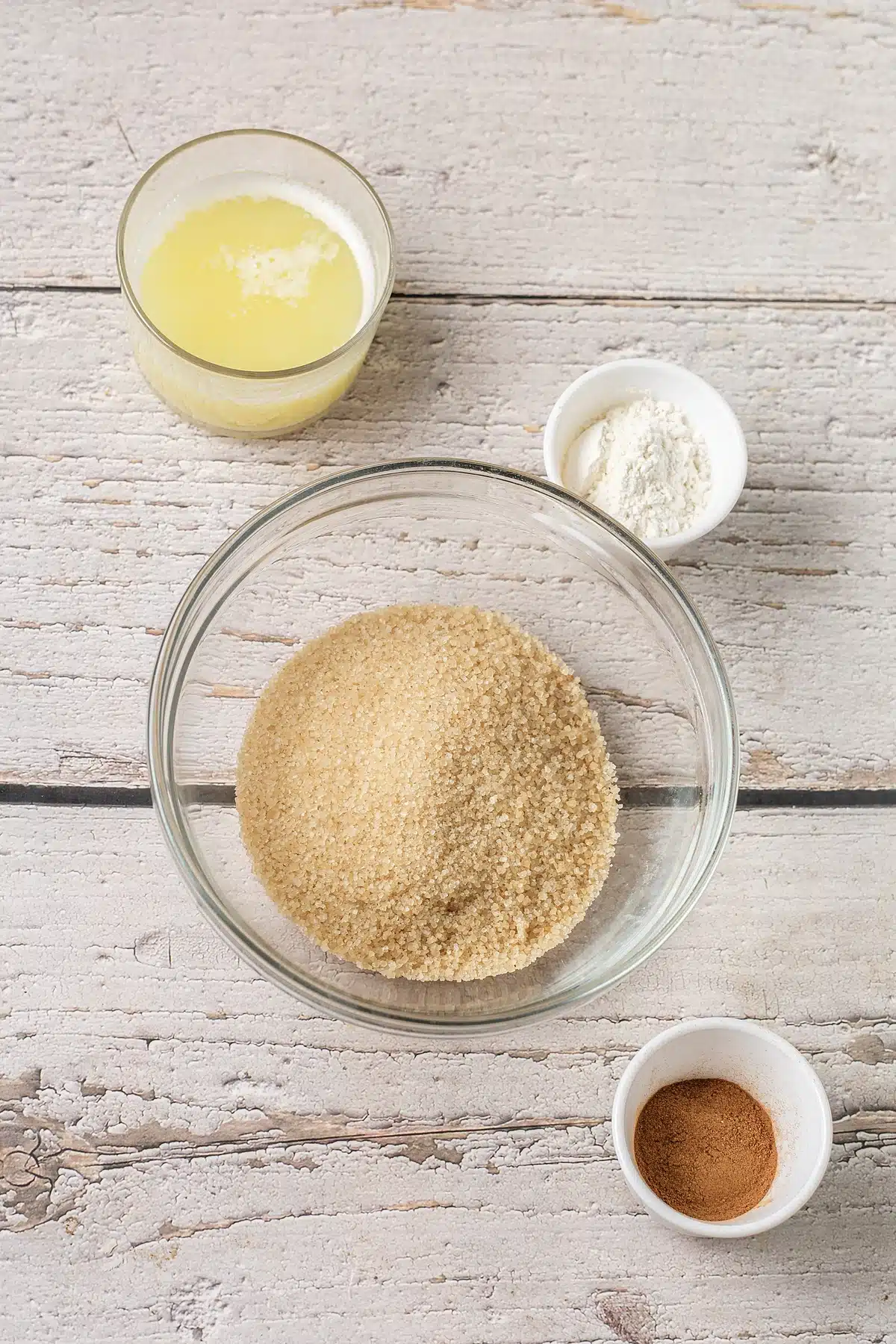 Melted butter, brown sugar and ground spice in glass bowls for the streusel