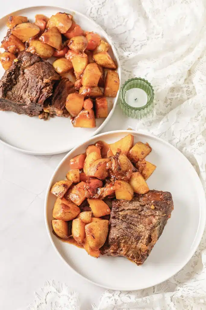 Classic pot roast seen from directly above on two white plates
