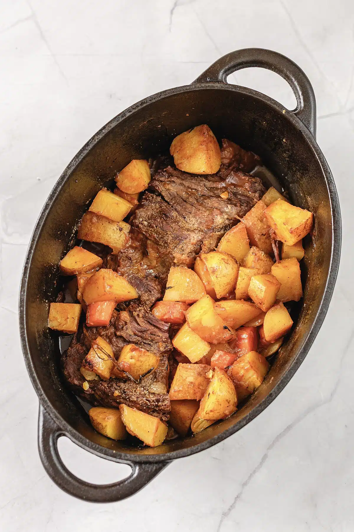 The finished braise in a black enamel Dutch oven