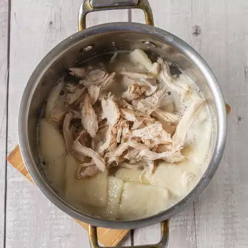 Shredded meat stirred into the thickened pot