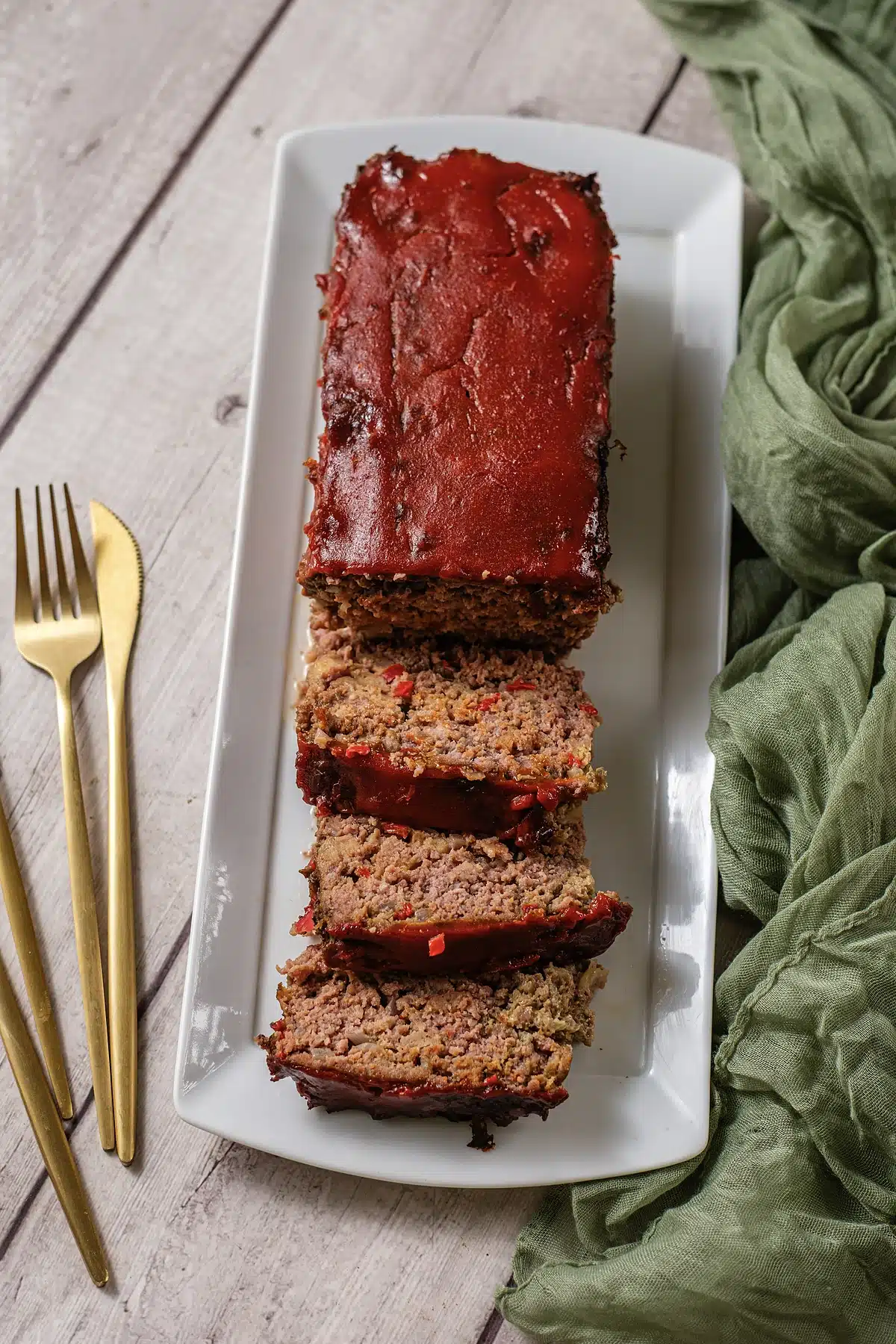Cracker Barrel meatloaf sliced on a narrow platter seen from directly above