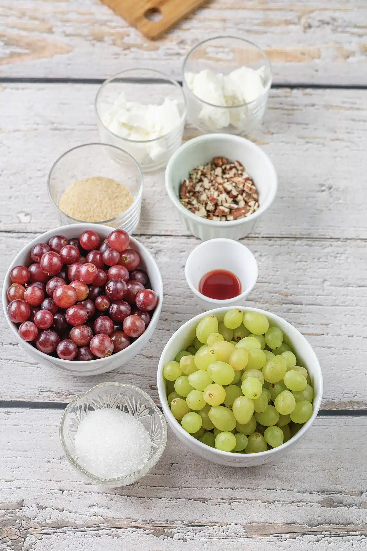 Cream cheese, sour cream, brown sugar and chopped pecans laid out in glass bowls