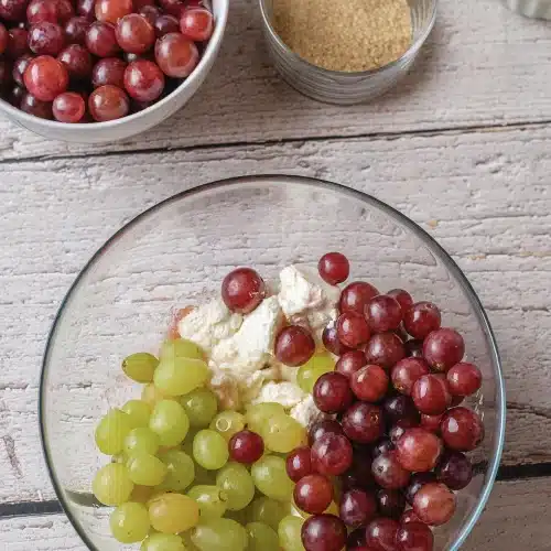 Red and green fruit sitting on top of the dressing before folding