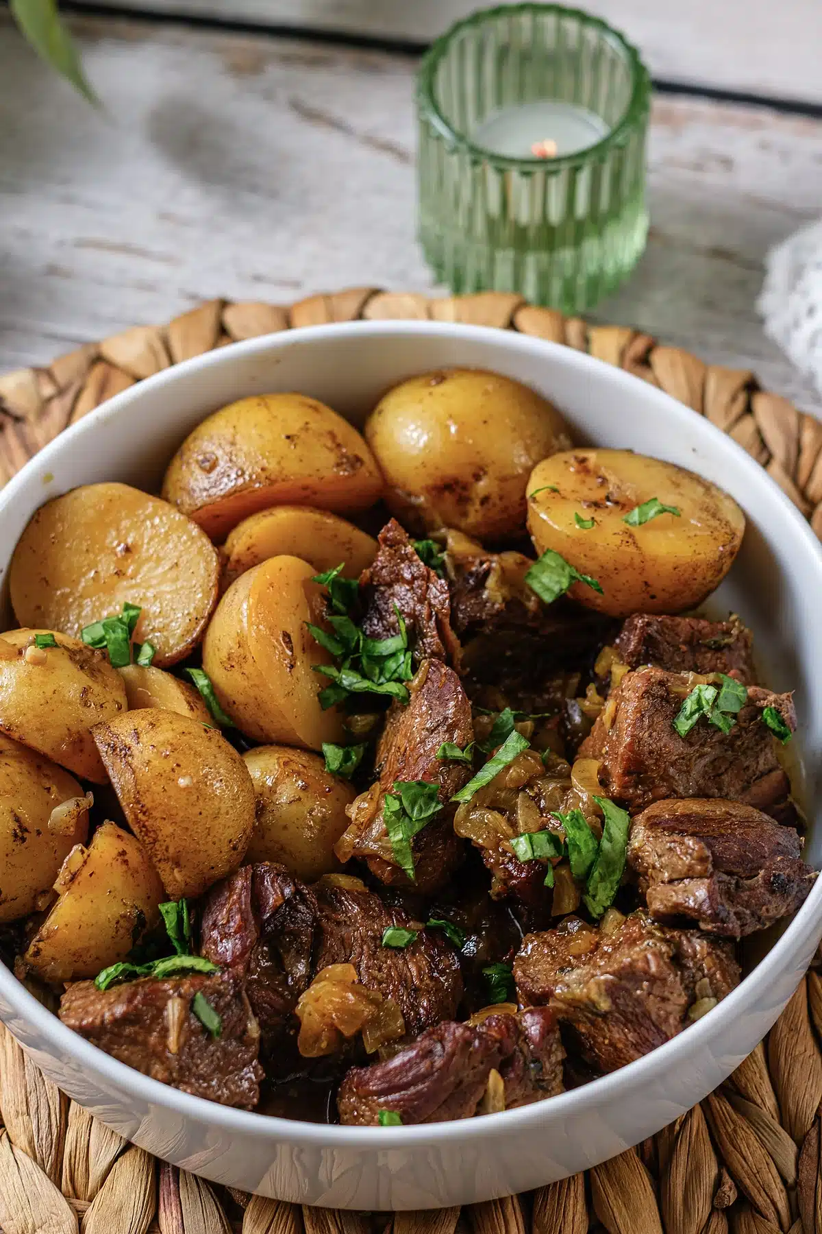 Crockpot steak and potatoes photographed at an angle with fresh parsley on top