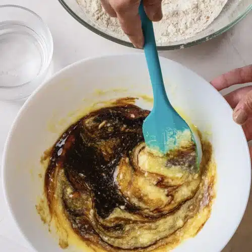 The molasses folded into the creamed mixture with a blue spatula