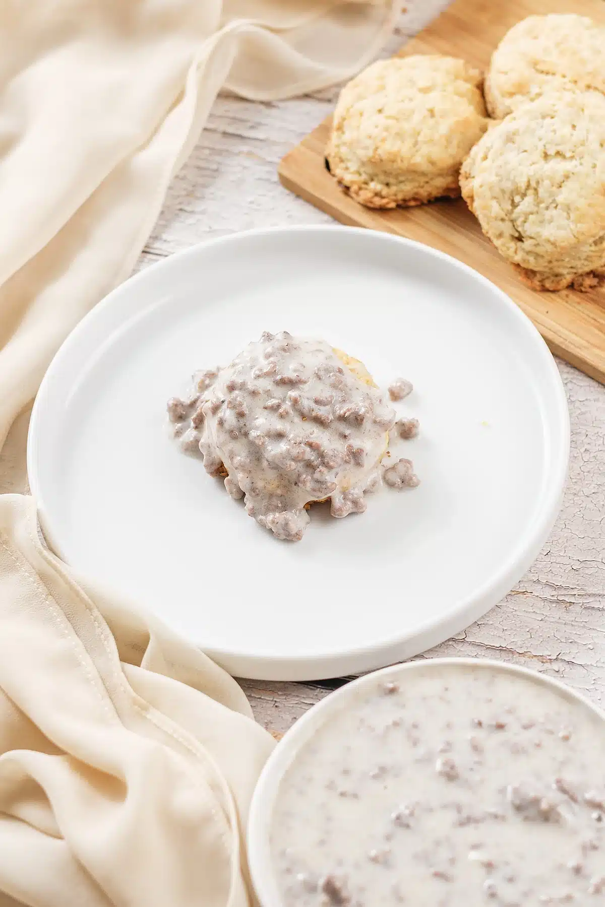 Hardee's sausage gravy poured over a split biscuit on a white plate