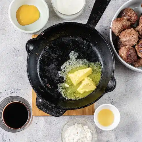 Cubes of butter melting in the empty pan for the roux