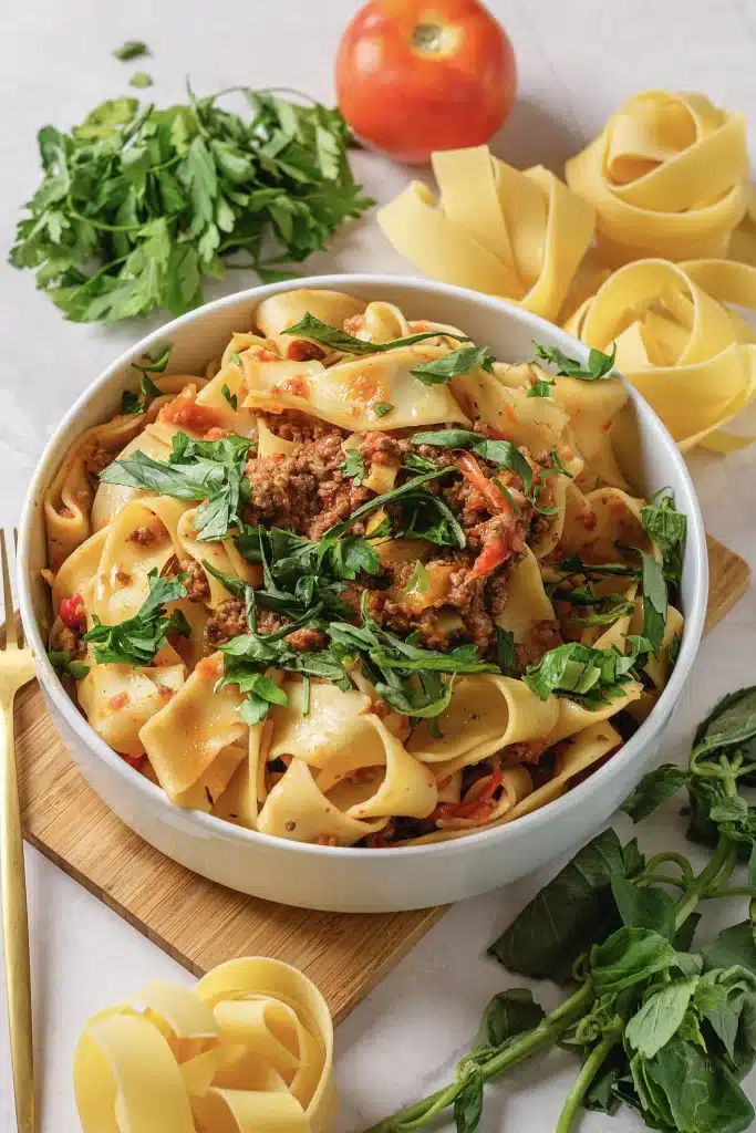 Italian drunken noodles seen from directly above in a white bowl