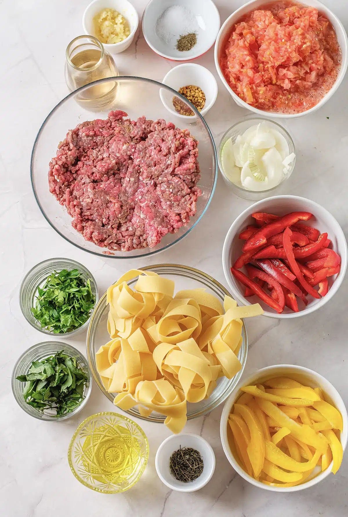 Ground sausage, sliced red and yellow peppers, crushed tomatoes, wine, herbs and dried pappardelle