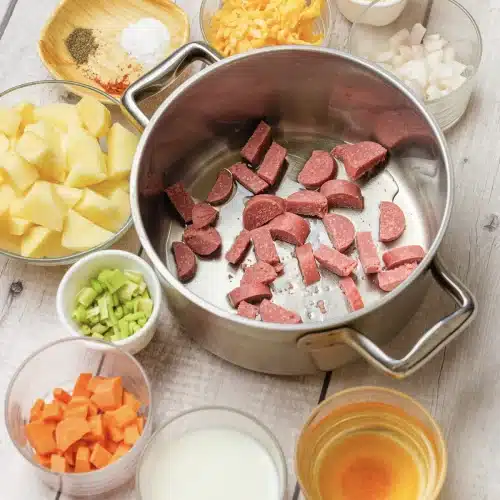 Pieces of kielbasa browning in the pot
