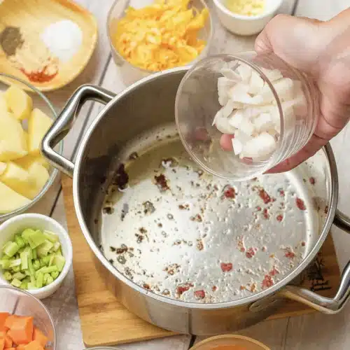 Diced onion added to the pot after the sausage has been removed