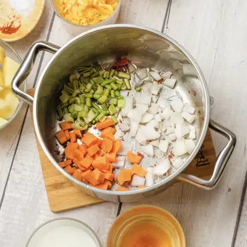 Onion, diced carrot and celery softening together in the pot