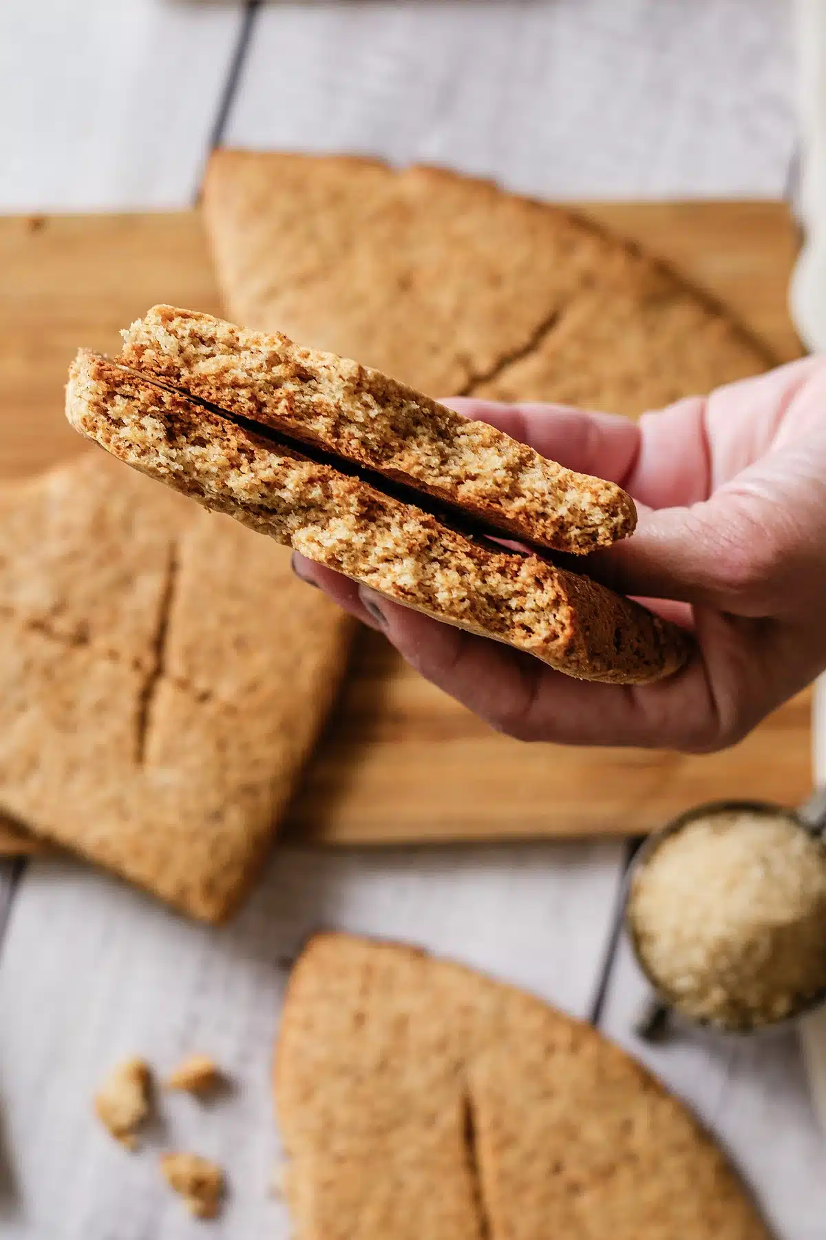 Elven bread broken open in one hand above the board