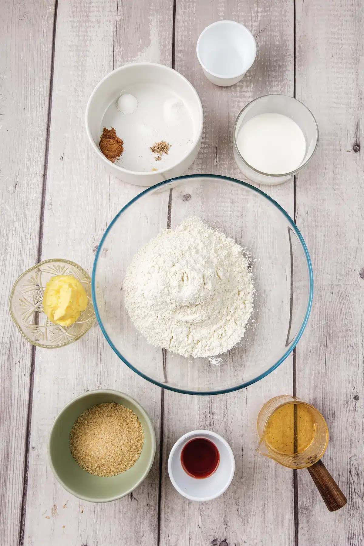Flour, butter, brown sugar, cream, honey and warm spices measured into bowls