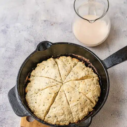 The round baked golden in the cast-iron skillet on a wooden board