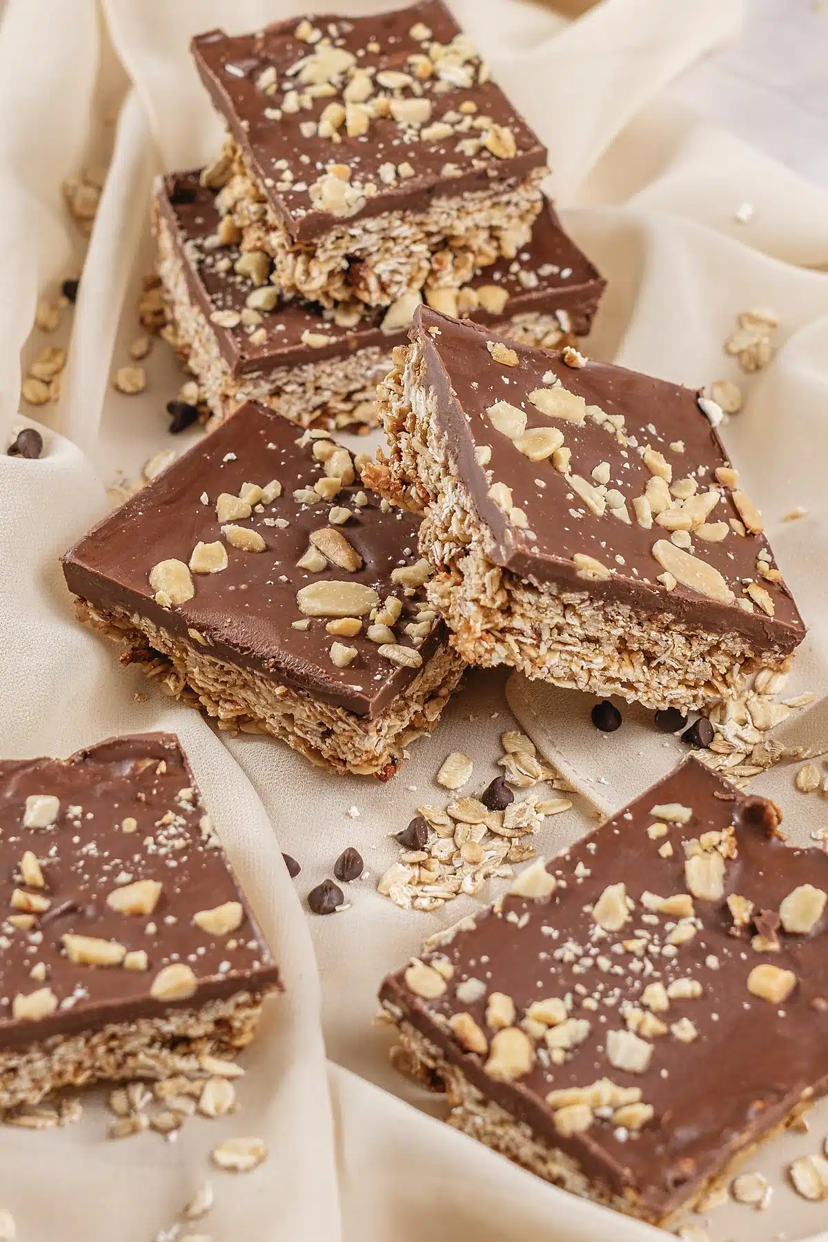 Oh Henry bars piled on a cream cloth with mini chocolate chips around them