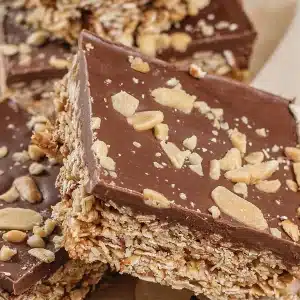 A single Oh Henry bar showing the oat base under a thick chocolate layer