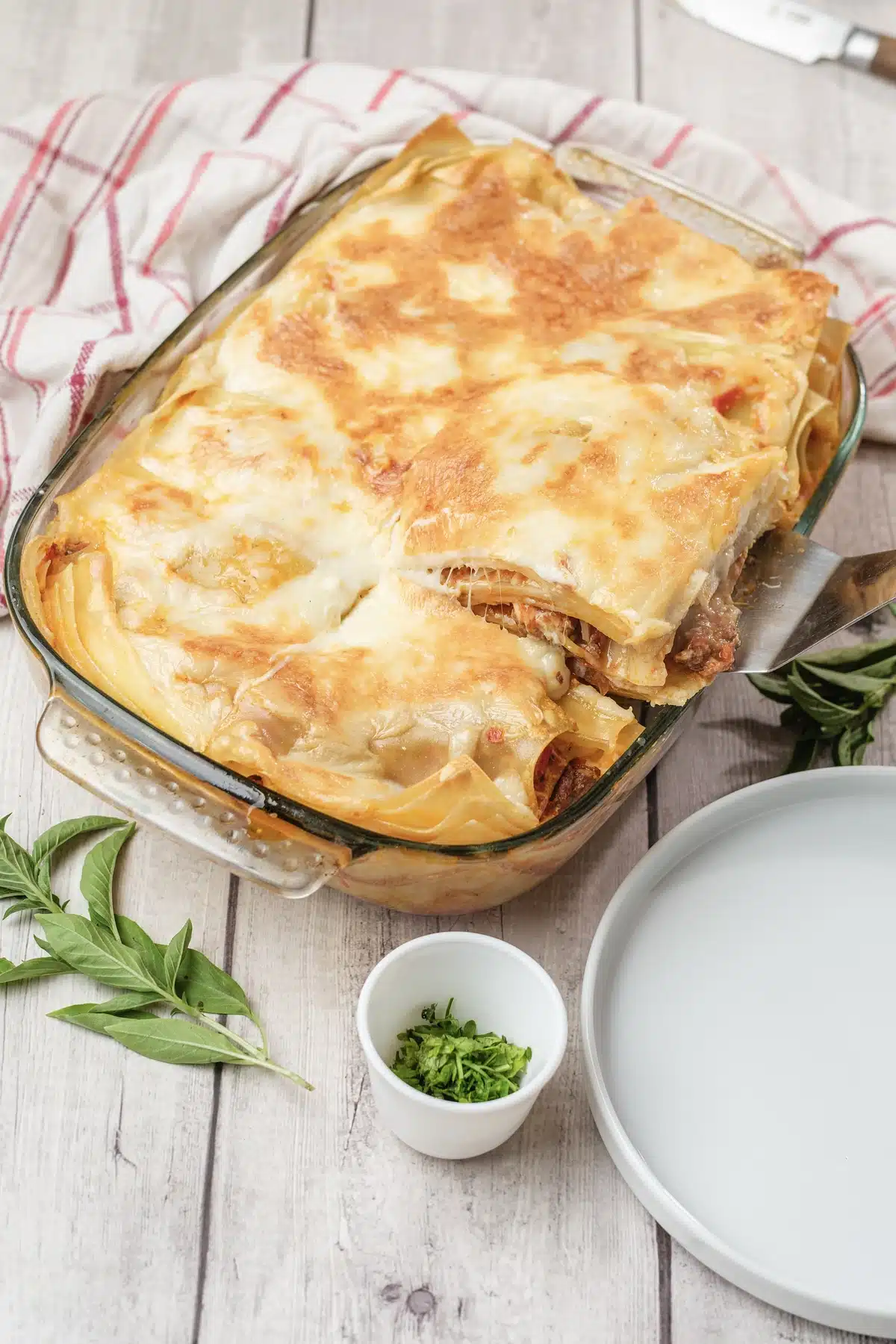 Olive Garden lasagna classico with the first square lifted out of the corner of the dish