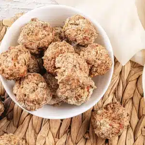 A single serving of pancake sausage balls in a small white bowl