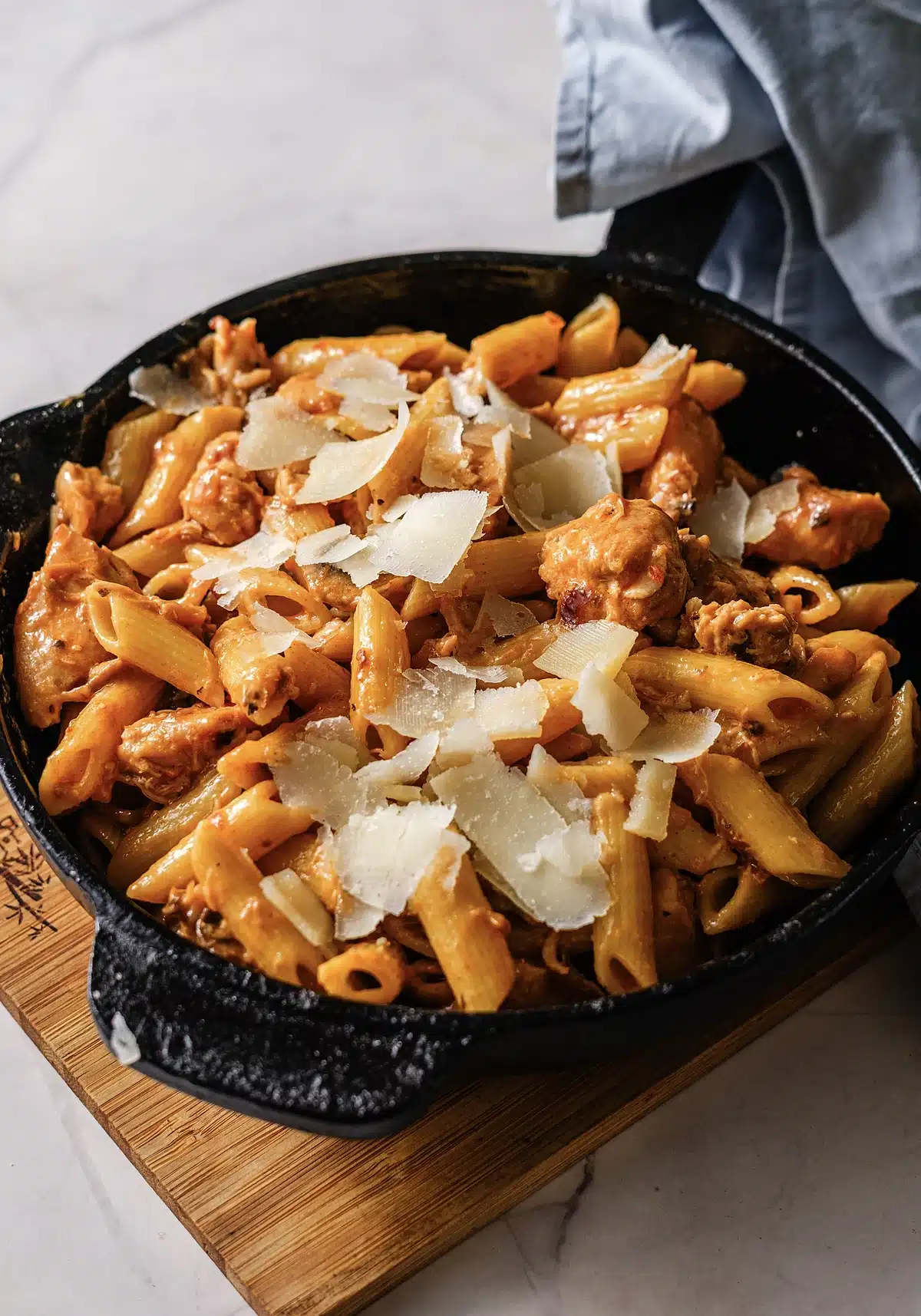 Cheesecake Factory Pasta Da Vinci served in the skillet on a wooden board