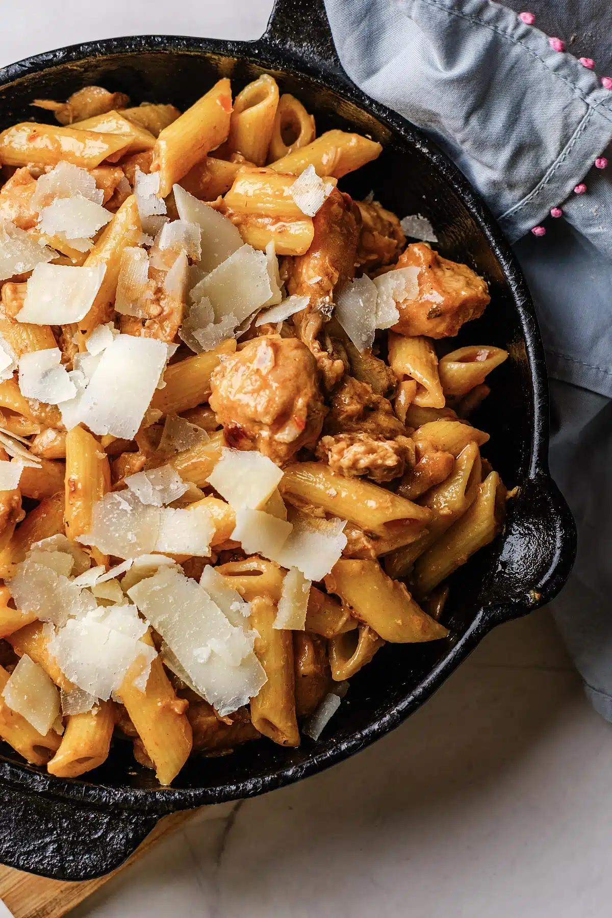 Pasta Da Vinci seen from above with shaved Parmesan over the penne