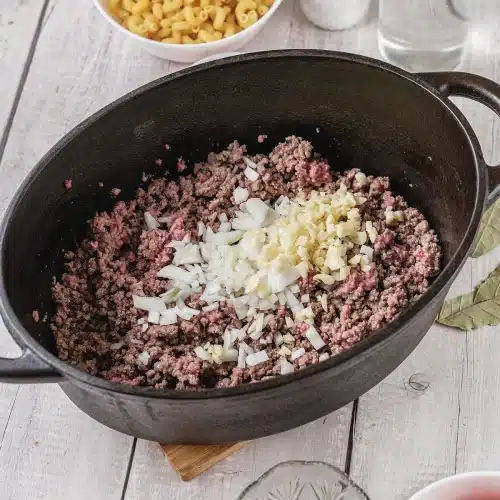 Onion and minced garlic stirred through the browned beef