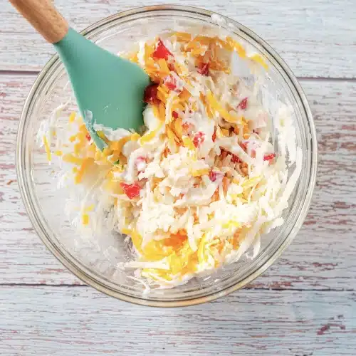 Grated cheddar, jack and diced peppers folded through the beaten base