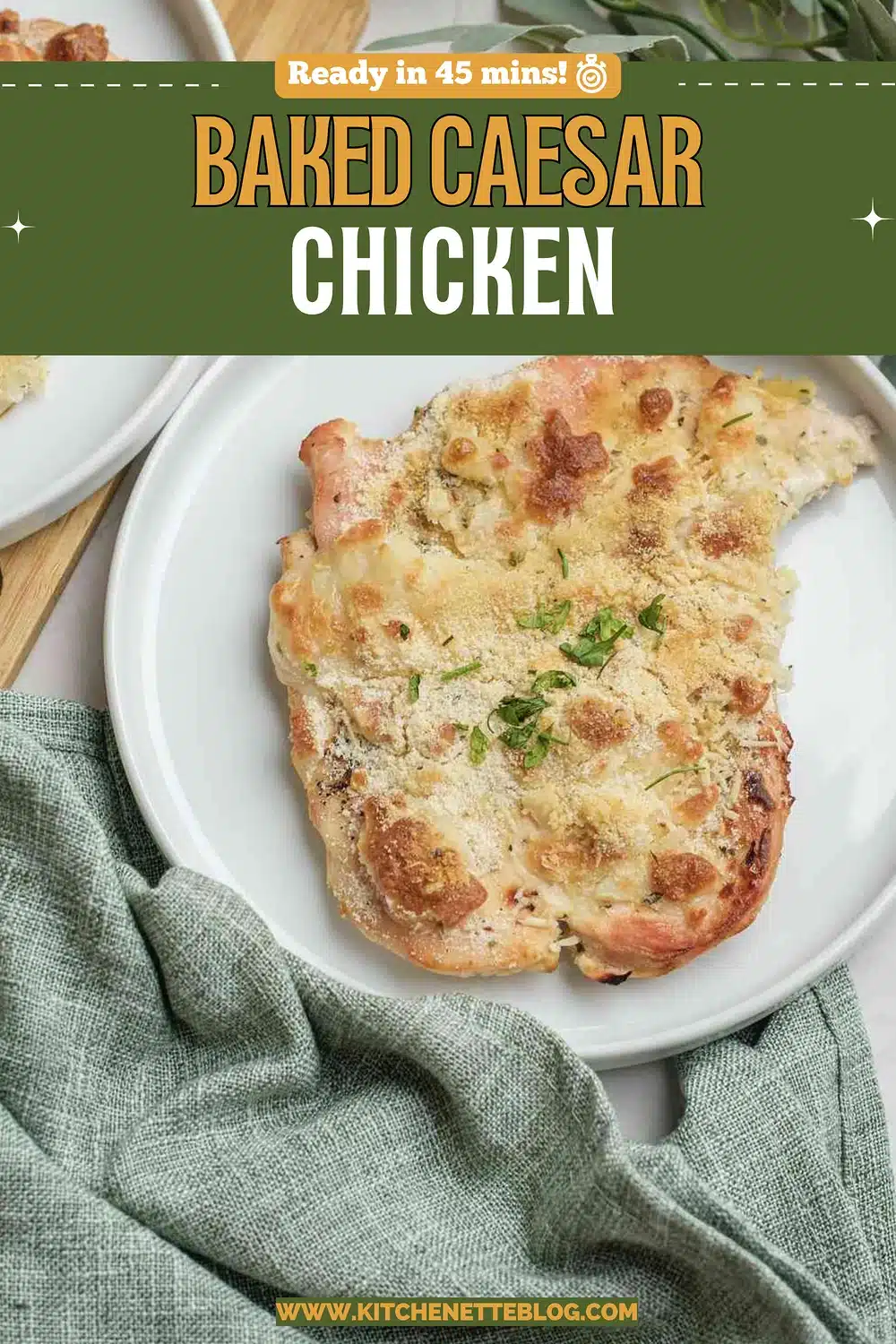A plate of golden, cheesy breast with parsley on a green napkin, with a second plate behind