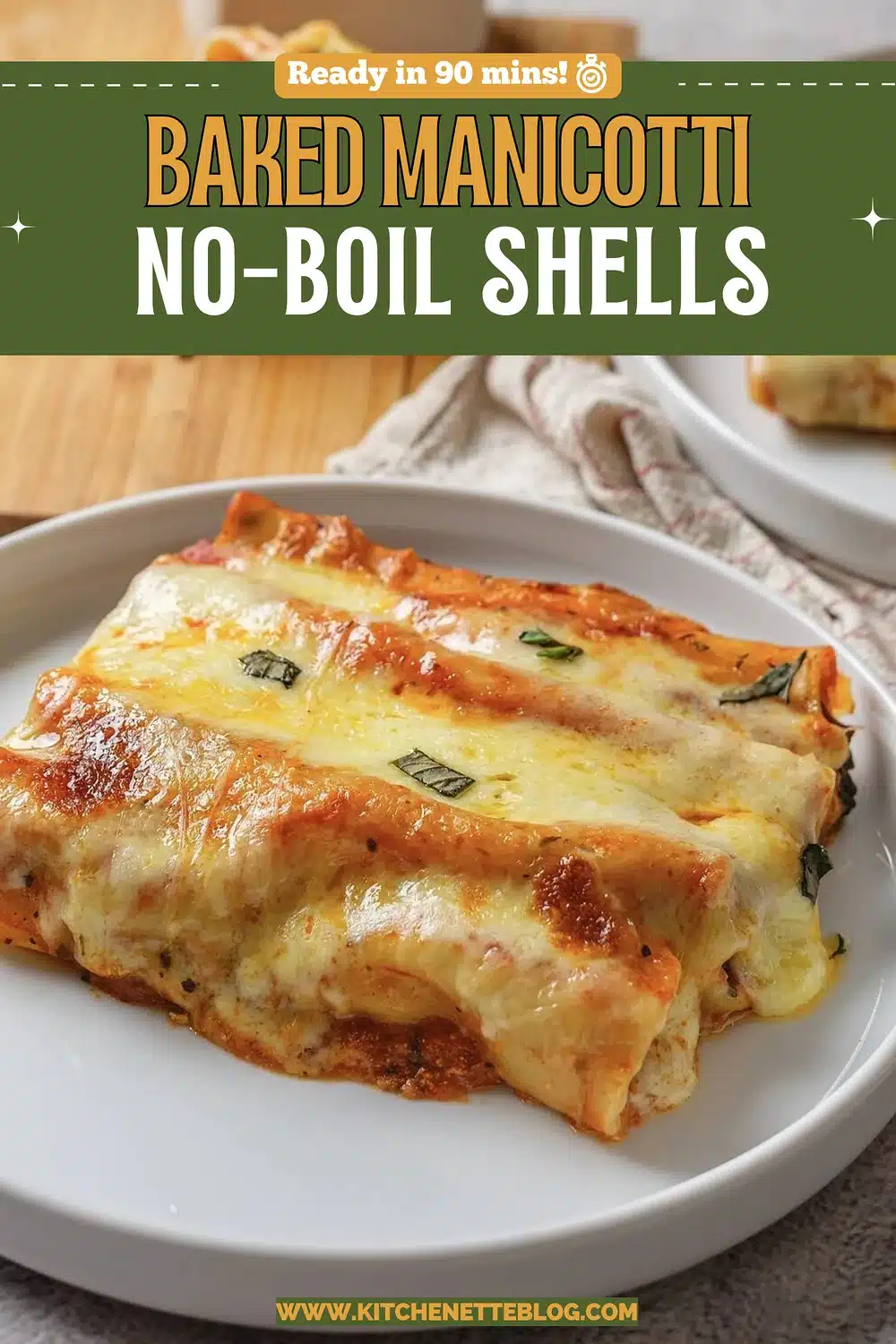 Two sauced pasta tubes under melted cheese on a white plate