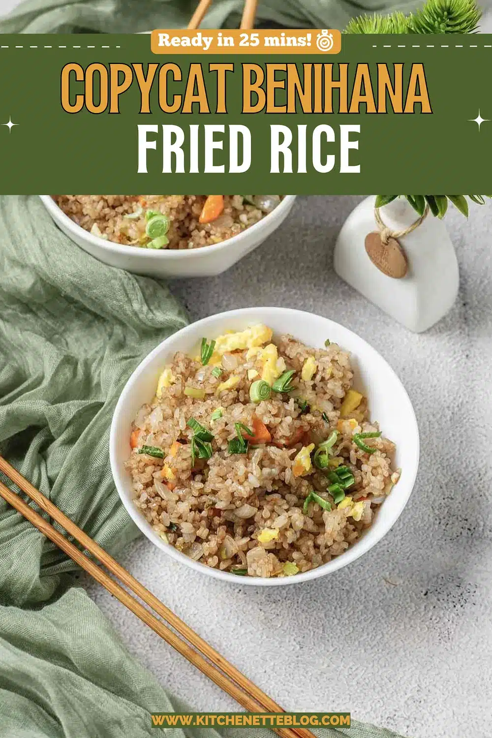 Two white bowls of golden grains with egg, carrot and scallion
