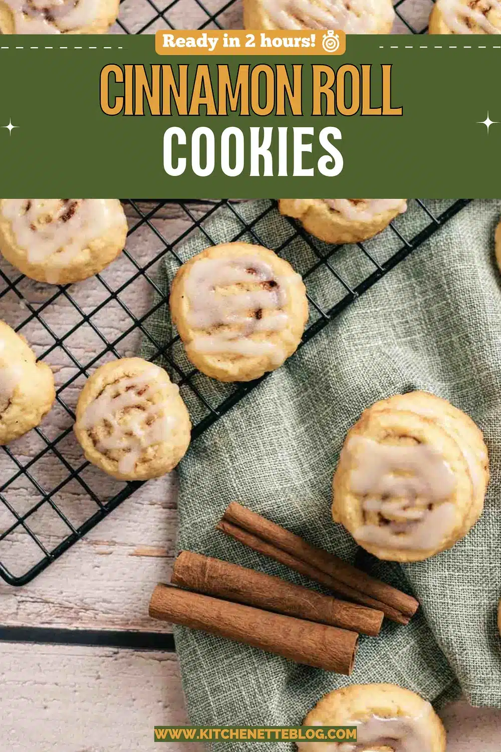 Glazed spiral shortbread rounds on a green napkin with bark sticks beside a wire rack