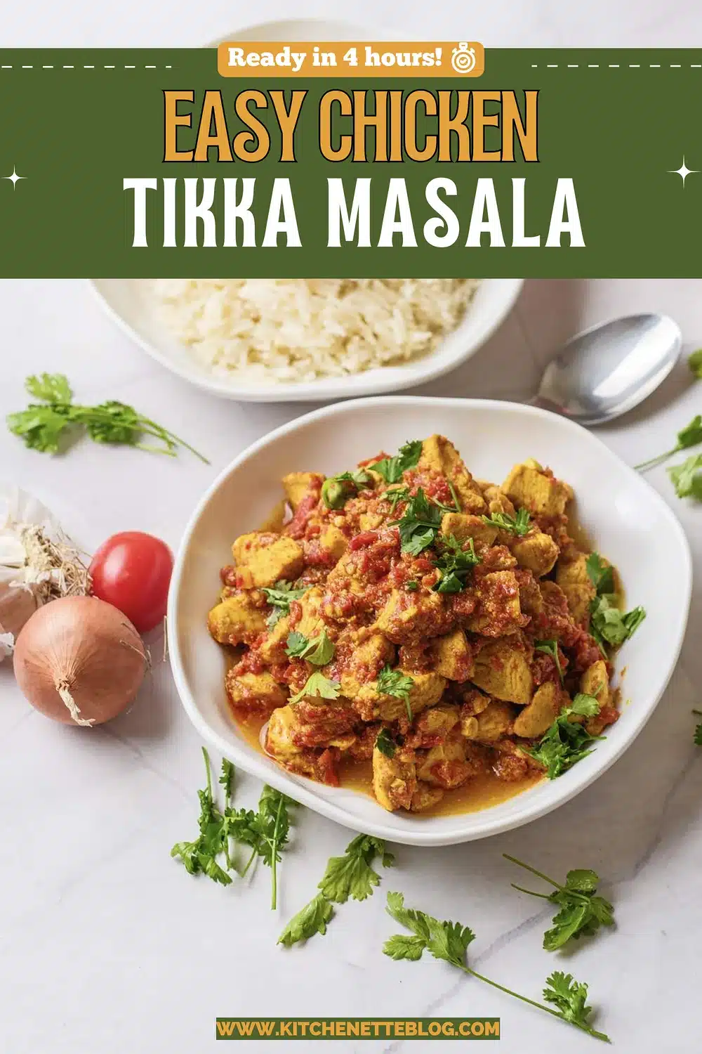 A plate of spiced cubes in thick red sauce with cilantro, with a bowl of rice behind