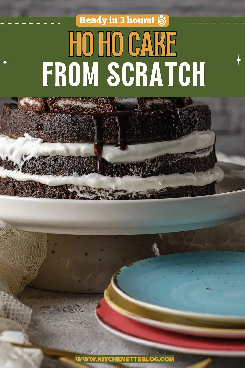 Dark layered dessert with white cream bands on a pale serving stand