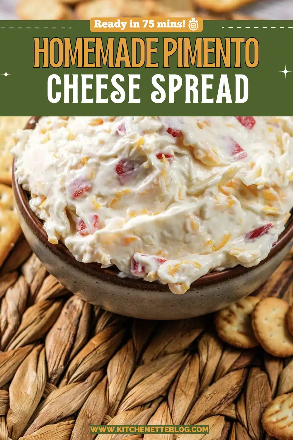 A stoneware bowl of creamy orange-flecked spread ringed with square crackers