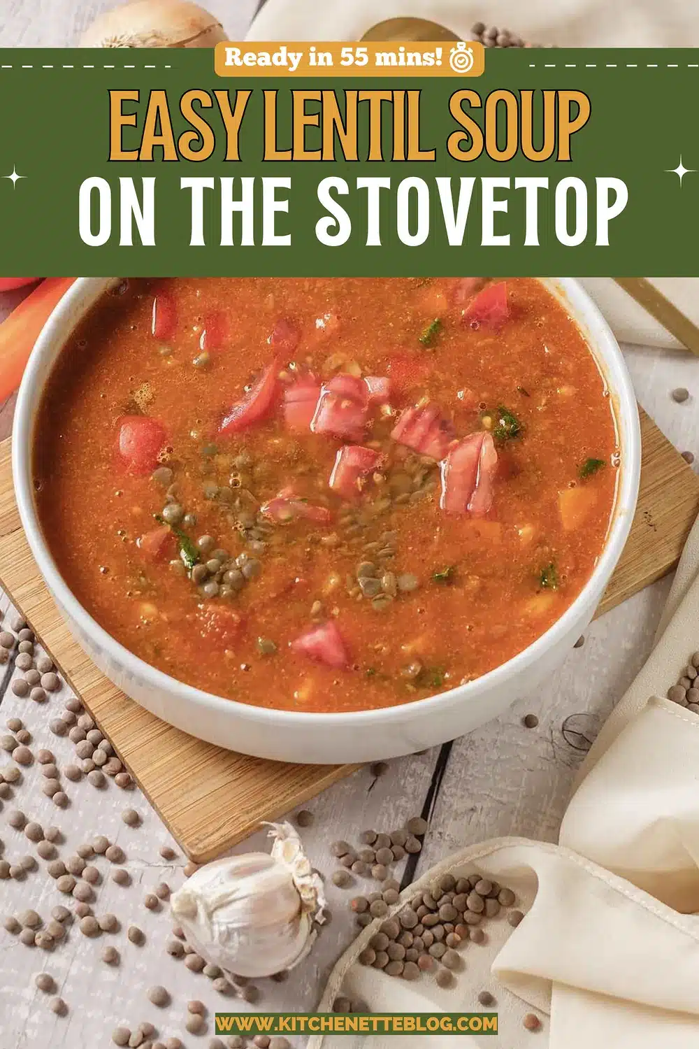 White bowl of chunky tomato and lentil broth on a wooden board