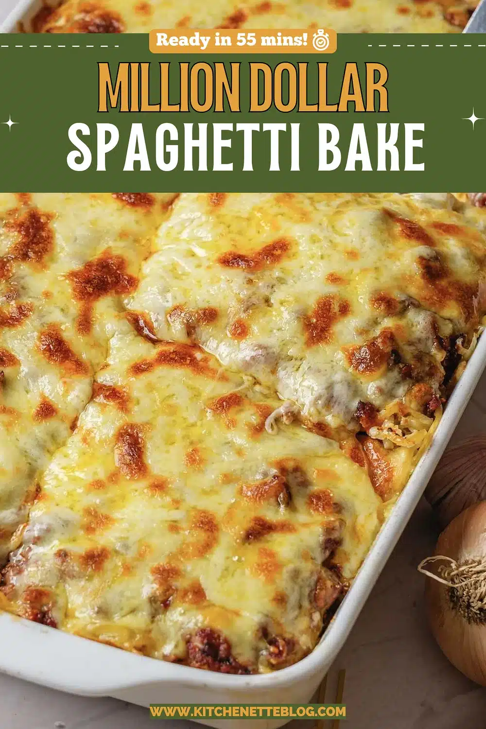 A browned cheese topped pasta bake in a white dish with a portion lifted
