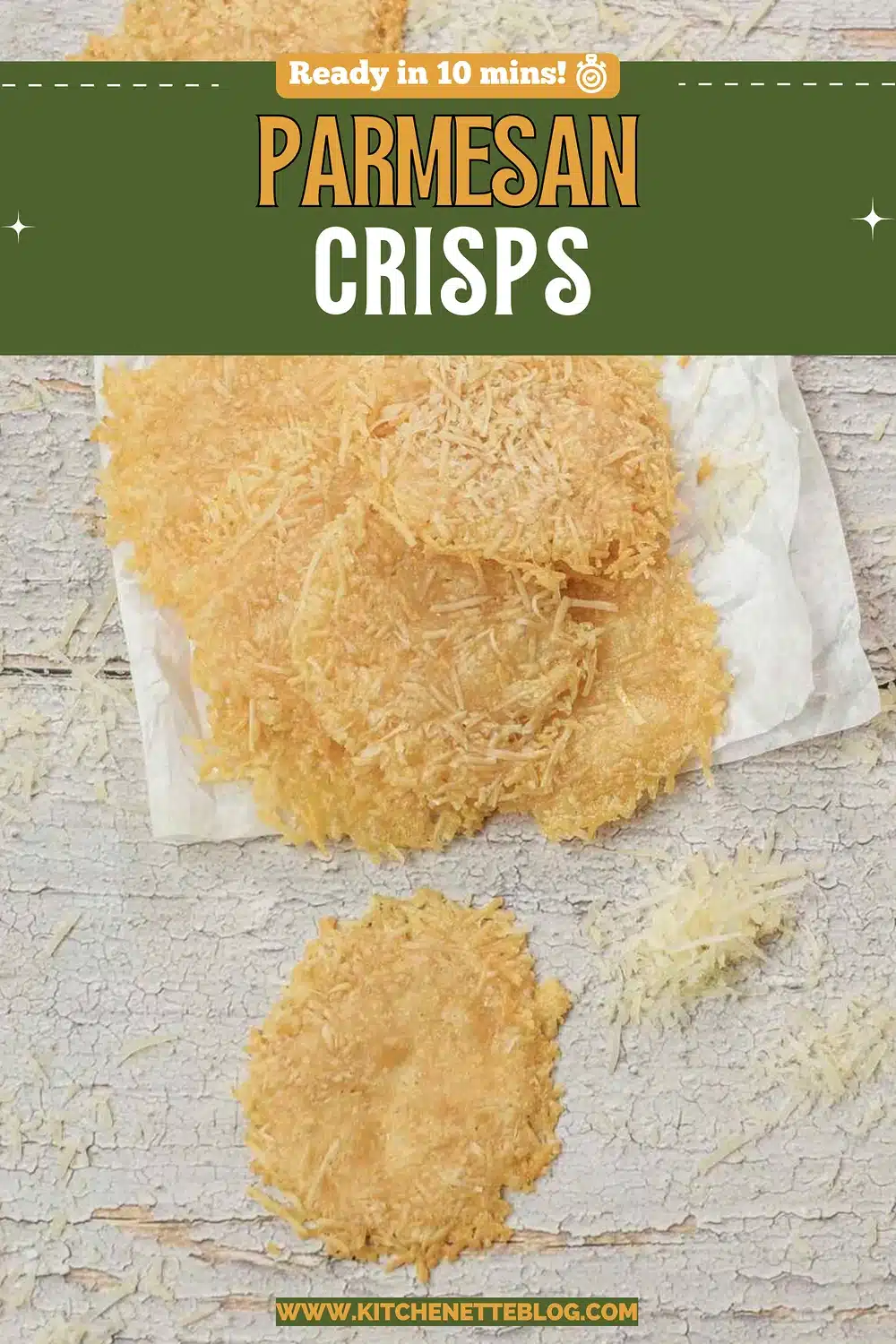 Golden lacy cheese wafers stacked on a paper towel on a white wooden board