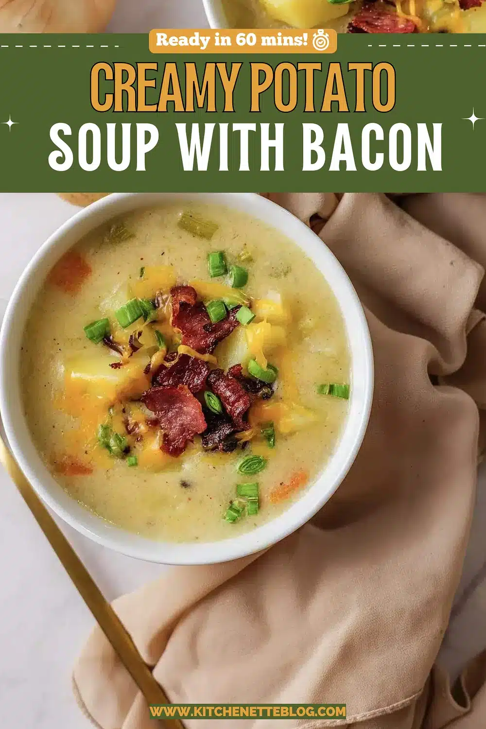 A white bowl of velvety chowder topped with crisp bacon and green onion