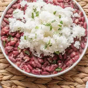 A single serving of red beans and rice in a shallow white bowl