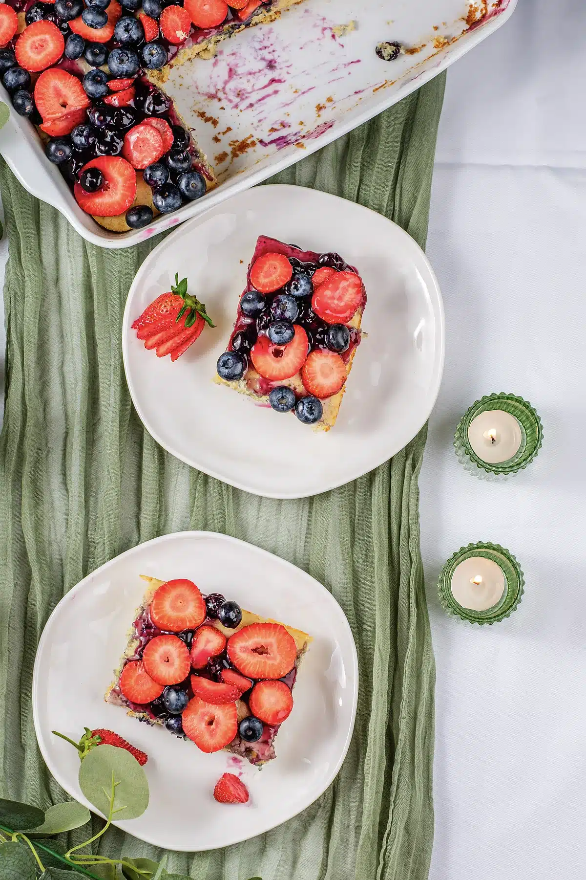 Sheet pan pancakes cut into squares and served on two white plates