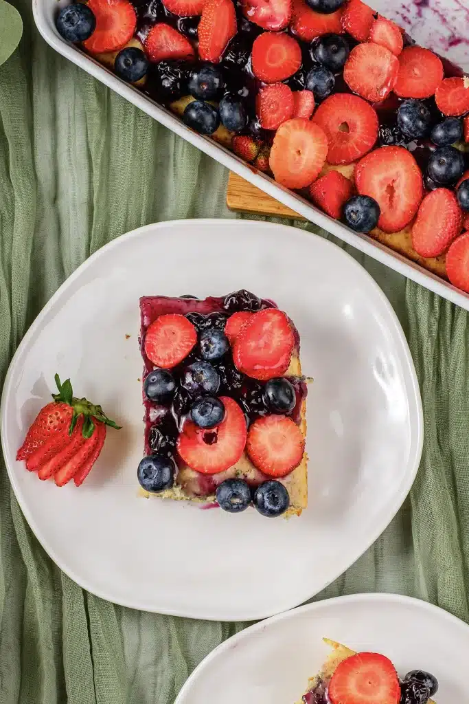 Sheet pan pancakes served as one berry topped square on a white plate