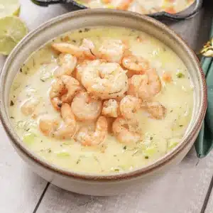 A single bowl of shrimp chowder topped with seared shrimp