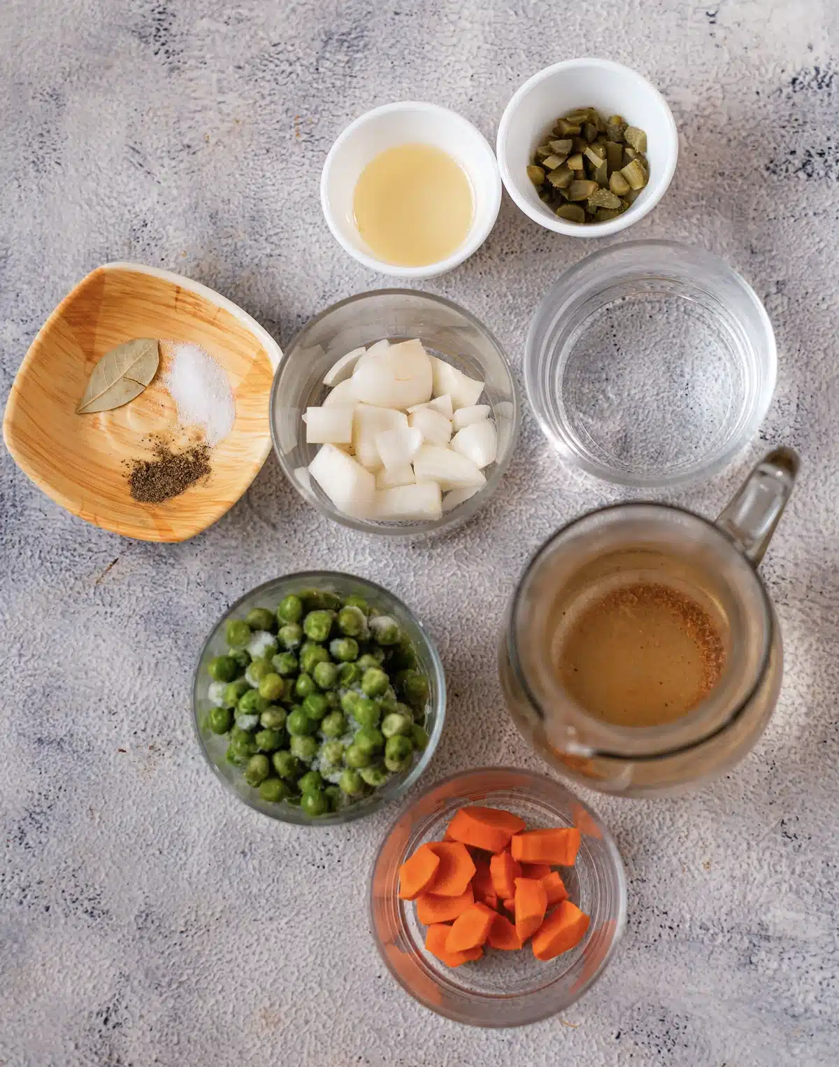 Frozen peas, onion, carrot, olive oil, broth, water, a bay leaf, salt, pepper and chopped pickle for the quick green pea version