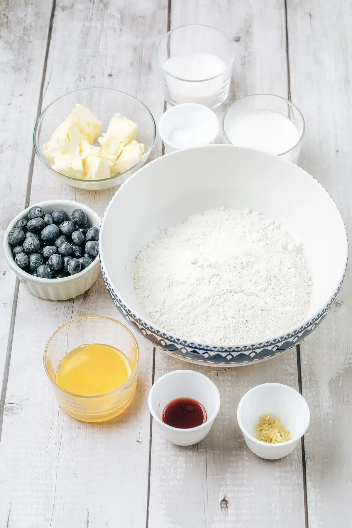 Blueberry scones ingredients: flour, cold cubed butter, cream, sugar and fresh berries