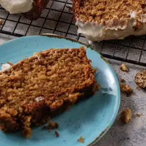 A single slice of gingerbread loaf on a blue plate