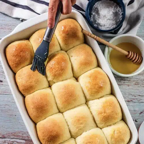 Melted butter brushed over the baked squares straight from the oven