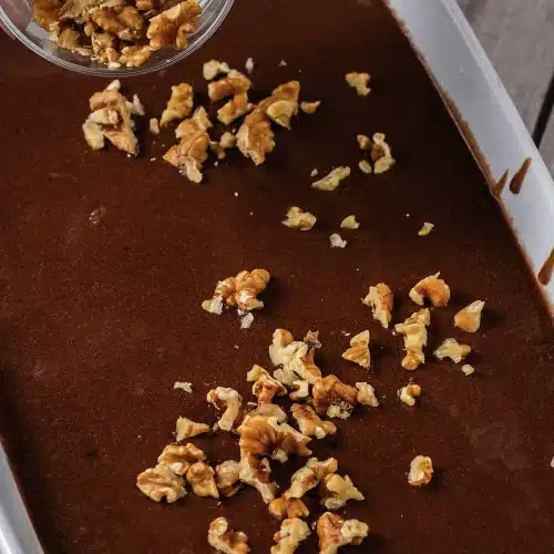 Chopped walnuts scattered over the wet icing