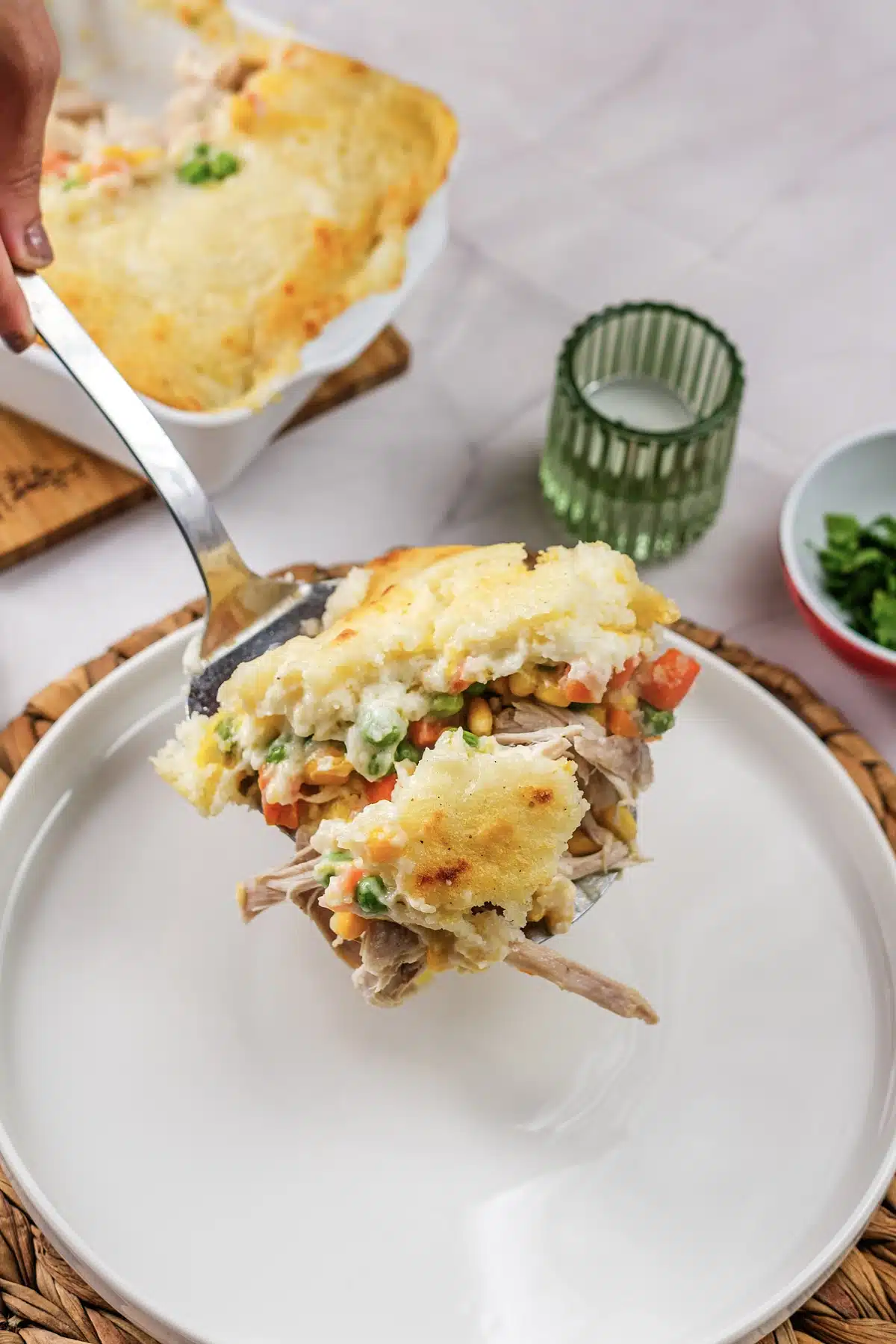 A serving lifted on a spatula from the dish onto a plate